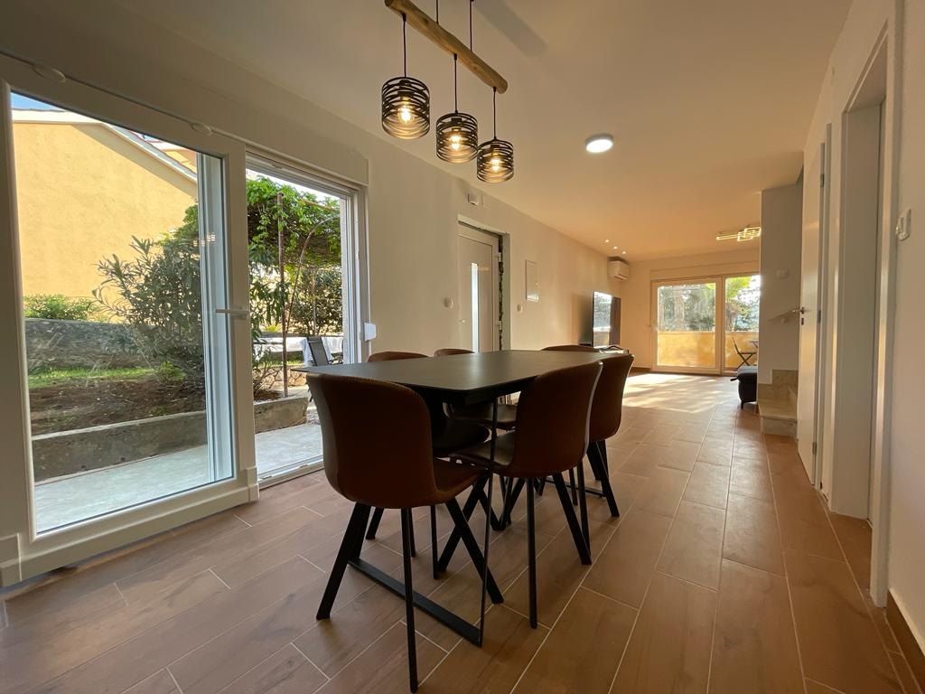 Dining table for six beside glass doors onto the terrace